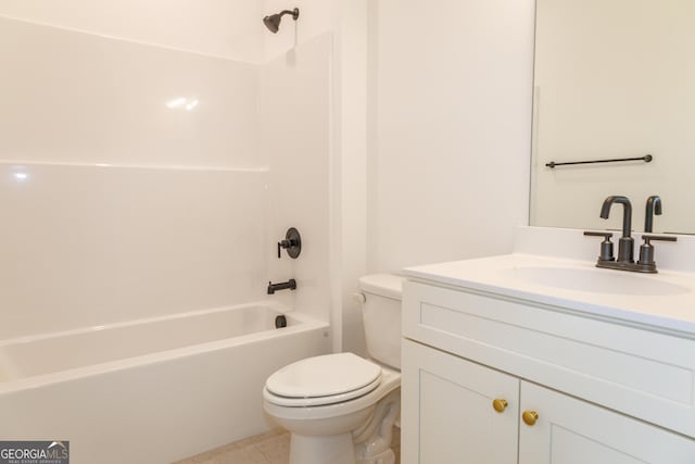 bathroom featuring toilet, vanity, tile patterned floors, and shower / washtub combination