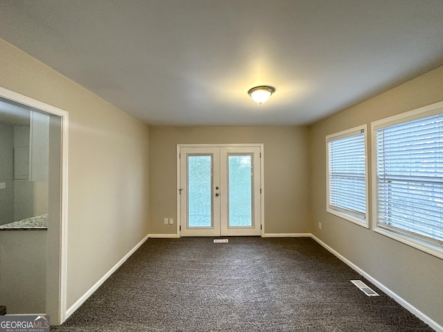 interior space with carpet, a healthy amount of sunlight, and french doors