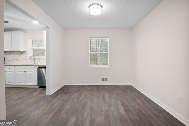 interior space with wood-type flooring and a textured ceiling