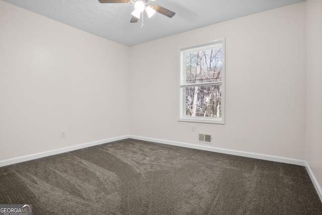 carpeted spare room with ceiling fan