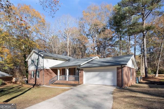 view of front of home with a front yard, a porch, and a garage