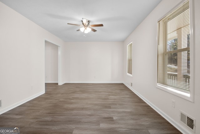 unfurnished room featuring ceiling fan and dark wood-type flooring