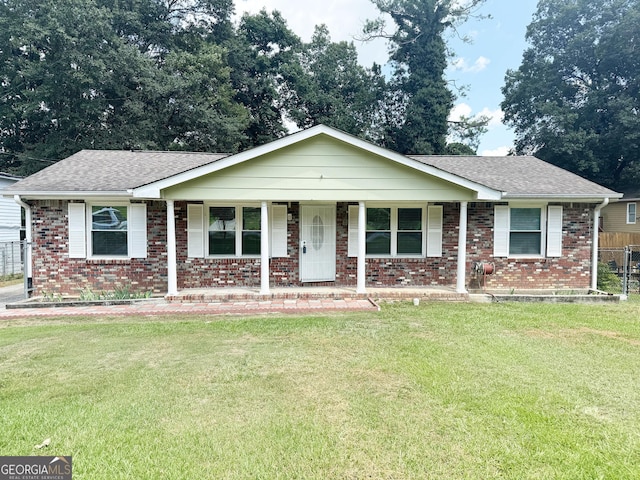 single story home with a front yard and covered porch