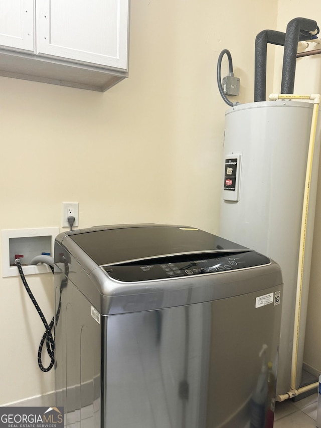 clothes washing area with washer hookup, cabinets, and tile patterned floors