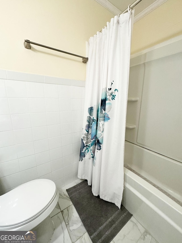 bathroom featuring shower / tub combo, toilet, tile walls, and ornamental molding