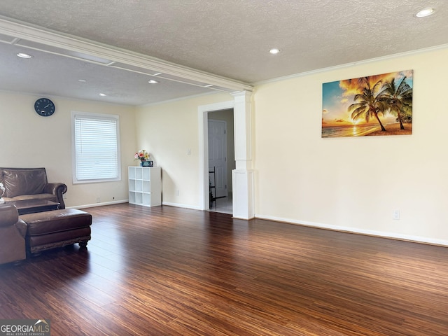 living room featuring crown molding, dark hardwood / wood-style flooring, and a textured ceiling