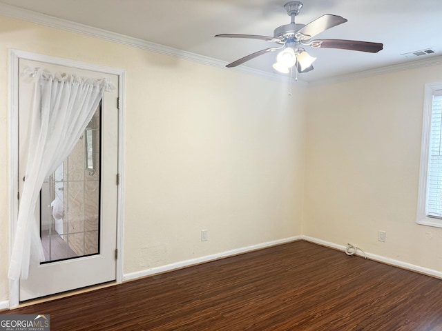 unfurnished room featuring dark hardwood / wood-style floors, ceiling fan, and crown molding