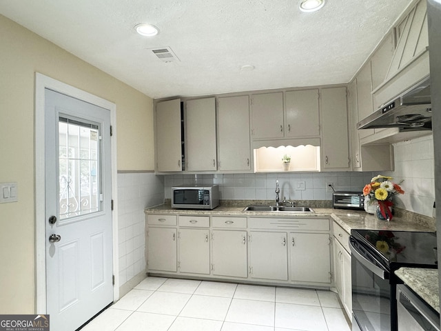 kitchen featuring gray cabinetry, sink, stainless steel appliances, a textured ceiling, and light tile patterned flooring