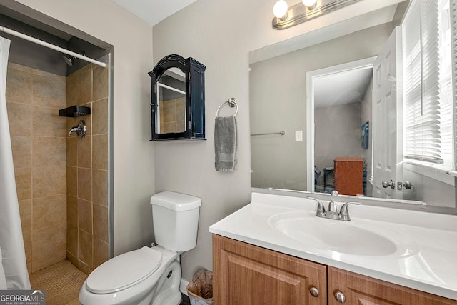 bathroom with curtained shower, vanity, and toilet