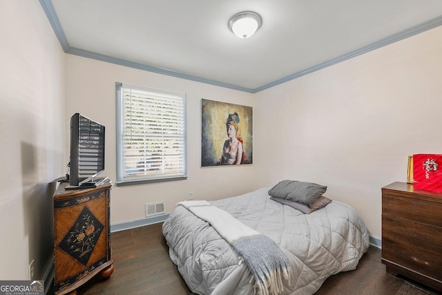 bedroom featuring dark hardwood / wood-style flooring and crown molding