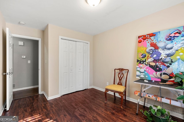 sitting room with dark wood-type flooring