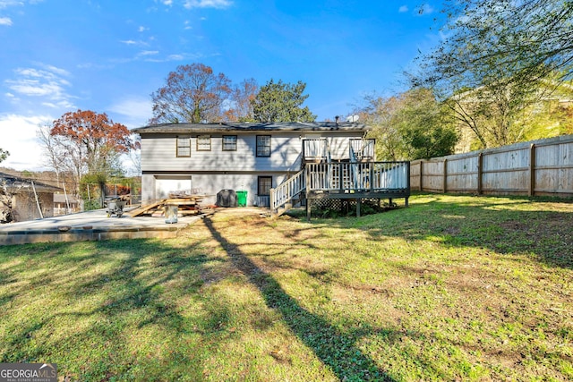 rear view of house featuring a yard and a wooden deck