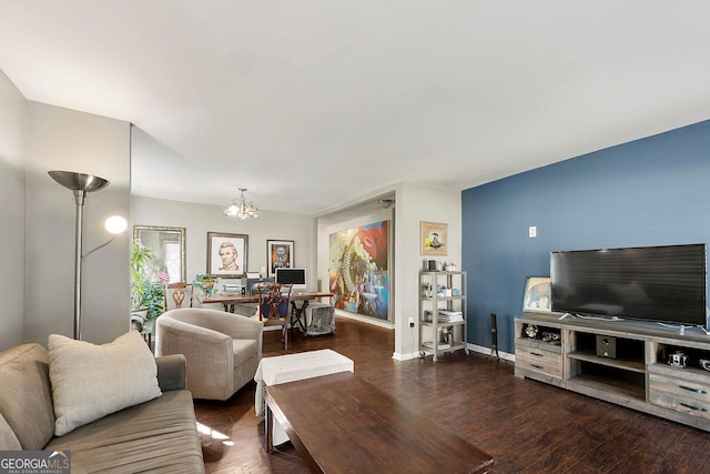 living room featuring a notable chandelier and dark wood-type flooring