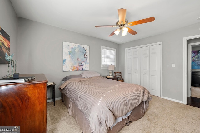 carpeted bedroom with ceiling fan and a closet