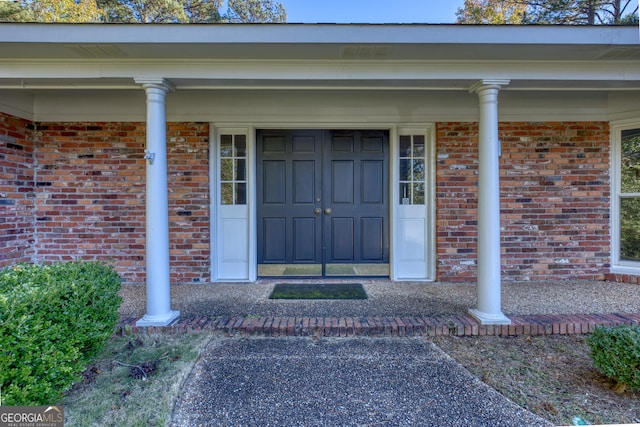 view of exterior entry featuring a porch