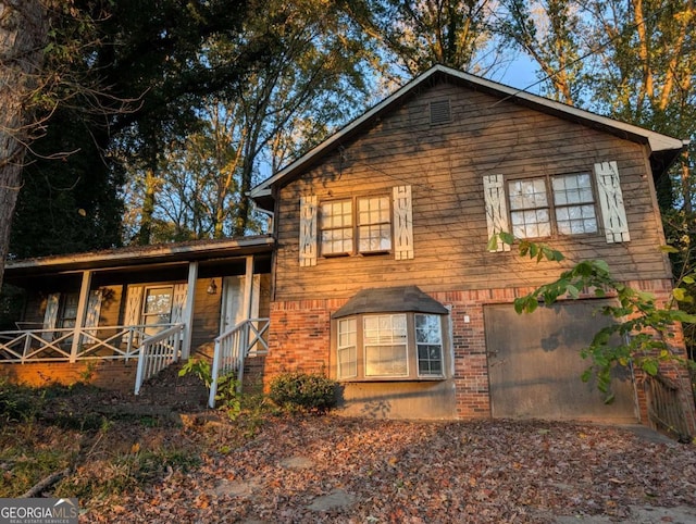 view of front of home featuring a porch and a garage