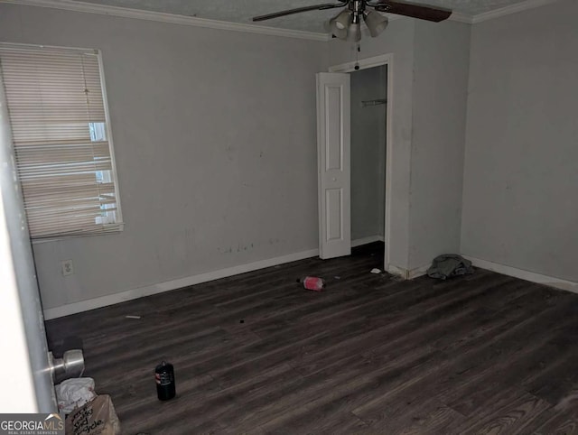 unfurnished room featuring ceiling fan, dark wood-type flooring, and ornamental molding