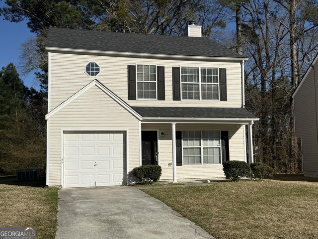 front facade featuring a garage, a front lawn, and central air condition unit