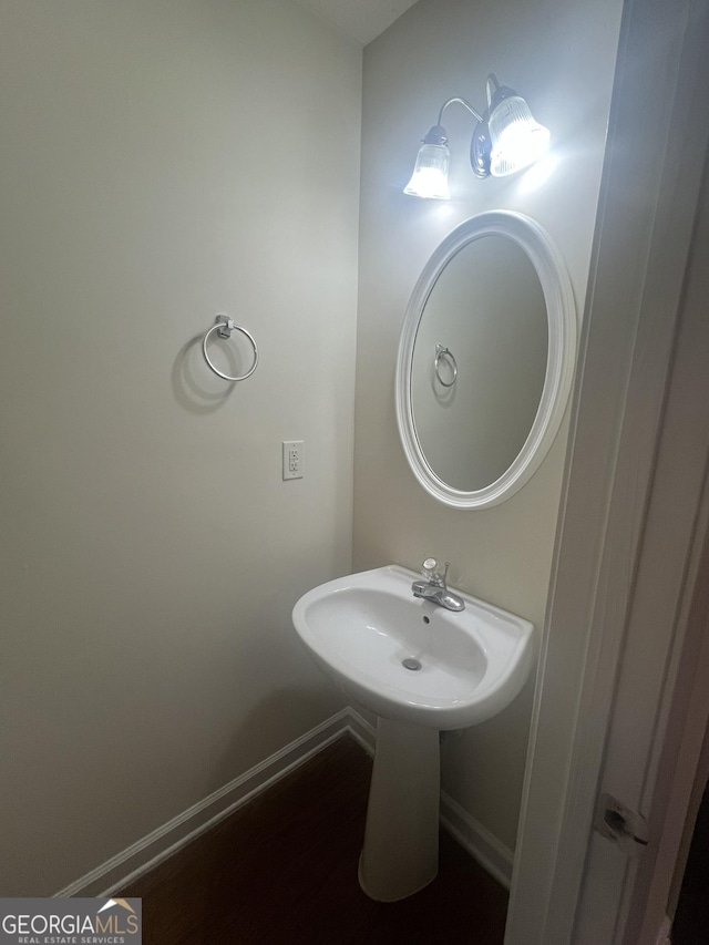 bathroom featuring baseboards and wood finished floors