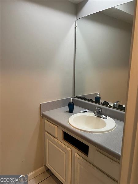 bathroom featuring tile patterned flooring and vanity