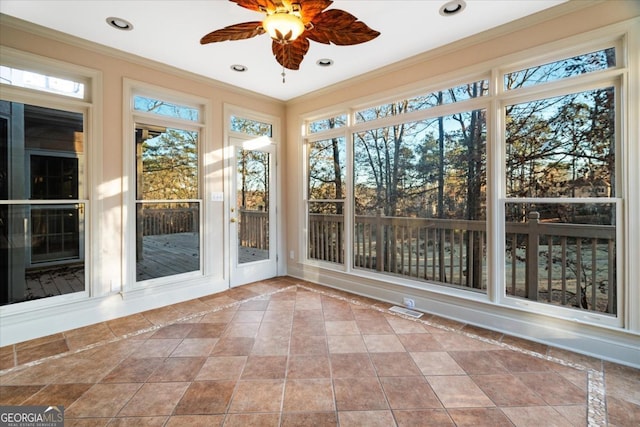 unfurnished sunroom featuring plenty of natural light and ceiling fan