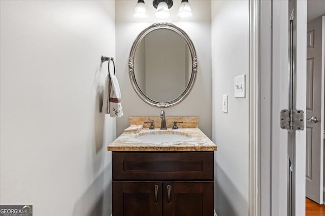 bathroom with vanity and hardwood / wood-style flooring