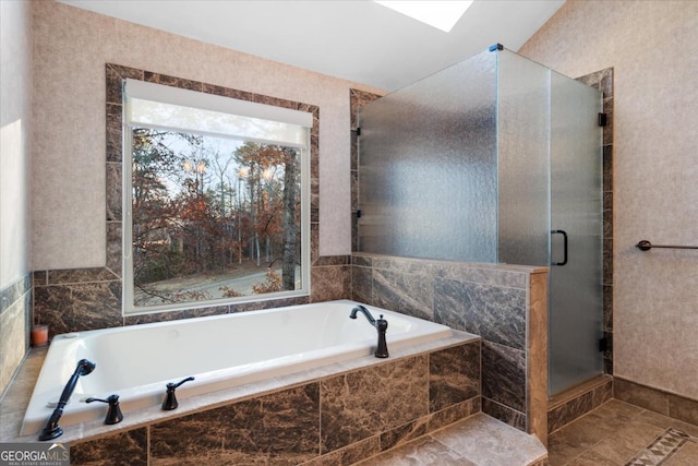 bathroom featuring tile patterned floors, vaulted ceiling, and shower with separate bathtub