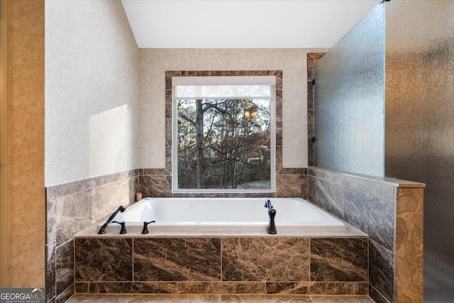 bathroom featuring tiled bath