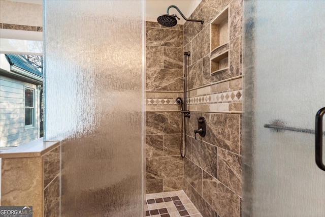 bathroom featuring a shower with shower door