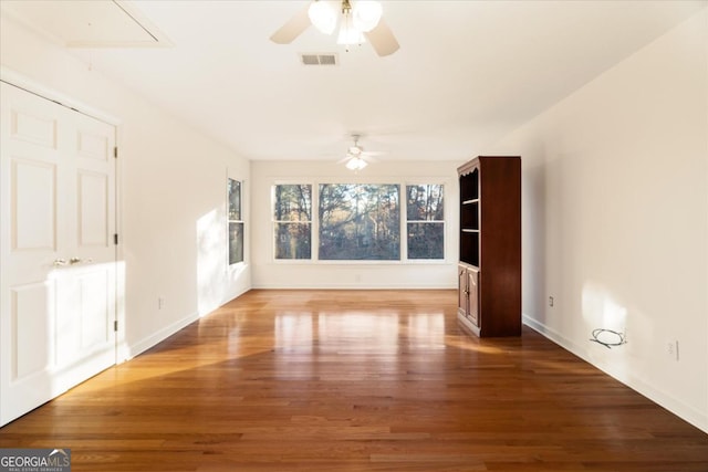 spare room with hardwood / wood-style flooring and ceiling fan