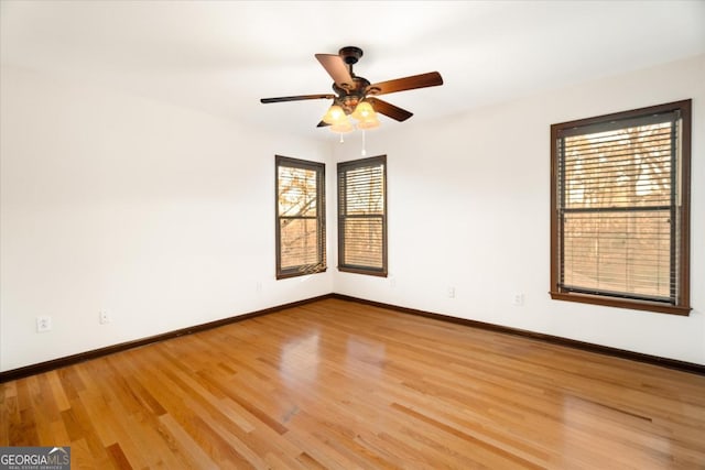 unfurnished room with hardwood / wood-style floors, plenty of natural light, and ceiling fan