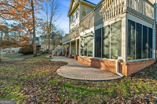 view of side of property with a patio