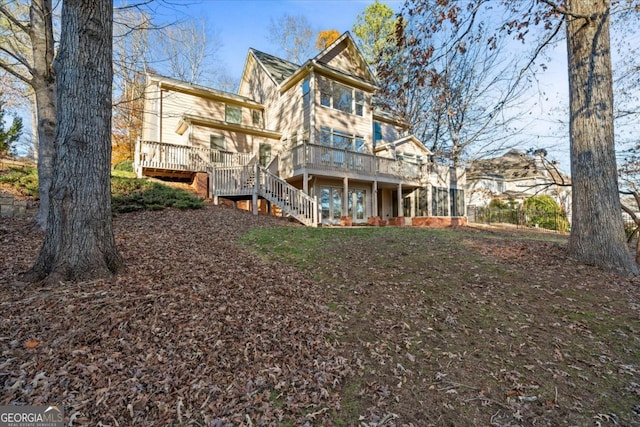 back of property featuring a wooden deck