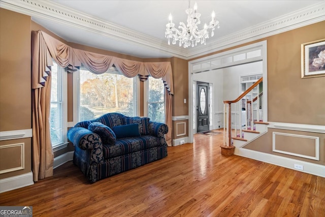 interior space with hardwood / wood-style flooring, a chandelier, and ornamental molding