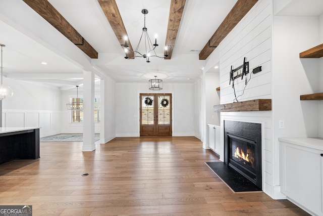 entrance foyer featuring a chandelier, french doors, hardwood / wood-style flooring, and beam ceiling