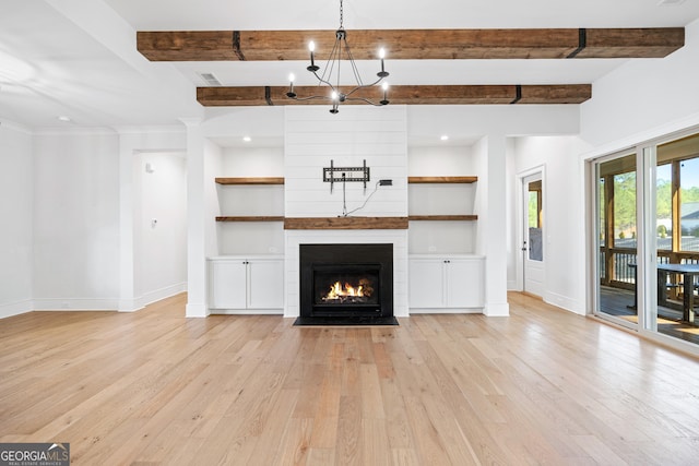 unfurnished living room with beam ceiling, light hardwood / wood-style floors, built in features, and a fireplace