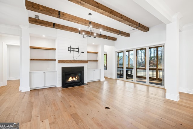 unfurnished living room featuring a fireplace, beam ceiling, and light wood-type flooring