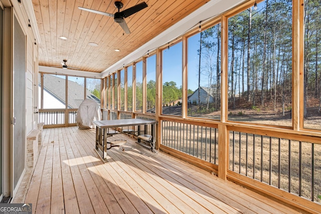 unfurnished sunroom with ceiling fan and wood ceiling