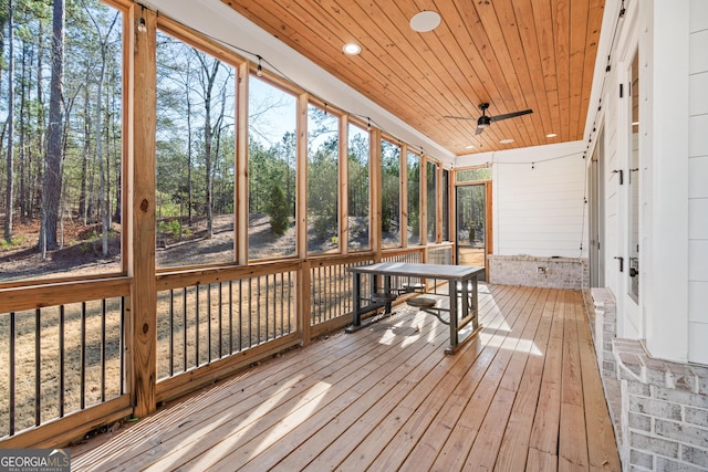 sunroom with ceiling fan and wood ceiling