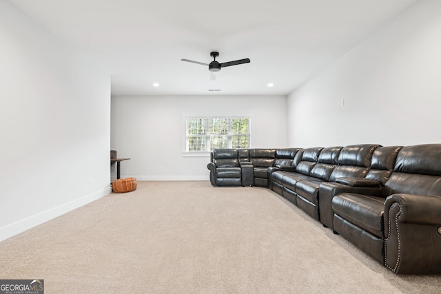 carpeted cinema room featuring ceiling fan