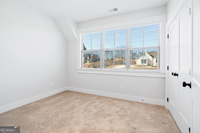 carpeted empty room with a healthy amount of sunlight