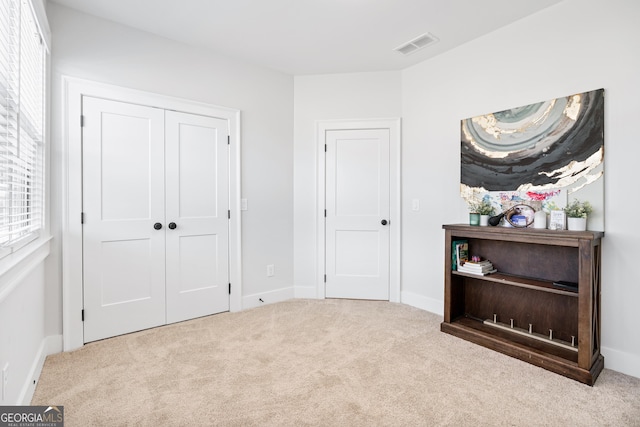 carpeted bedroom with a closet