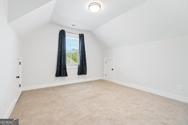 bonus room featuring light carpet and lofted ceiling