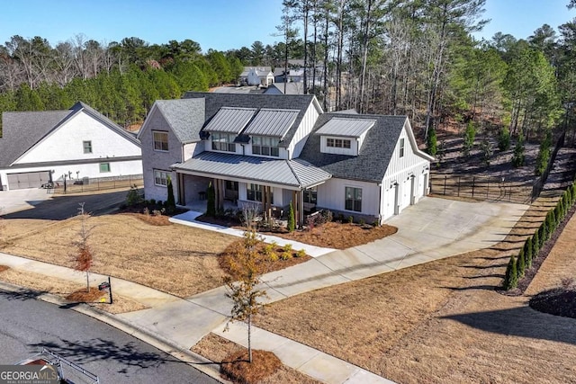 modern farmhouse style home featuring a porch and a garage