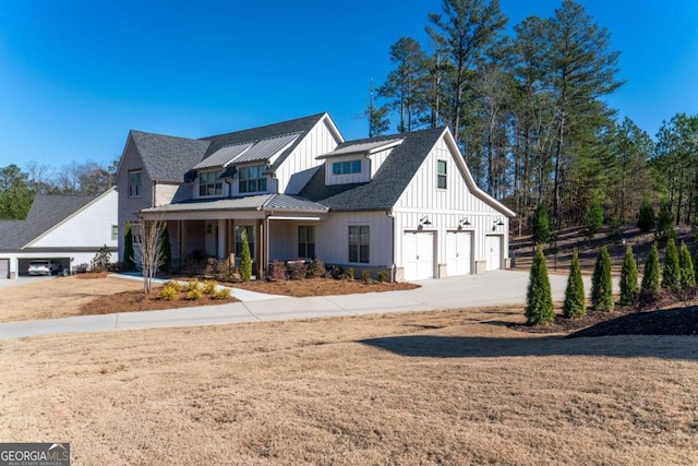 modern inspired farmhouse with covered porch and a garage