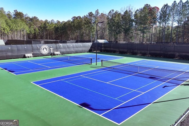 view of tennis court with basketball hoop