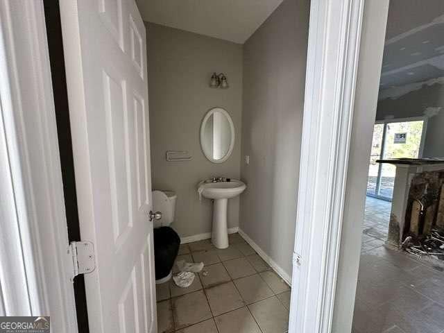 bathroom featuring tile patterned floors and a fireplace