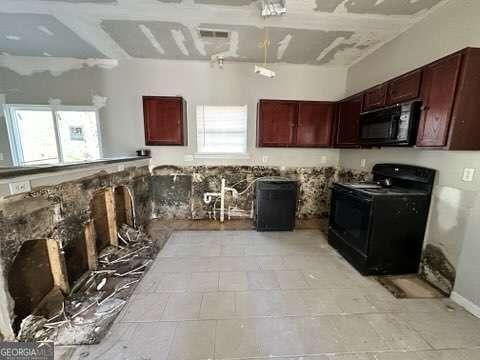 kitchen featuring plenty of natural light and black appliances