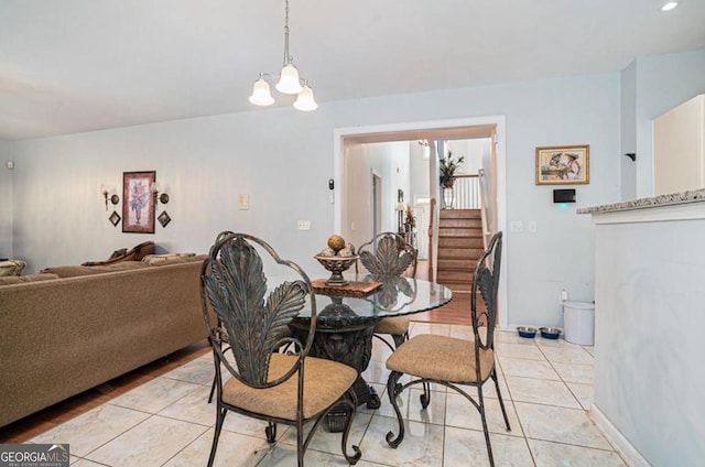 dining area featuring light tile patterned floors and a chandelier