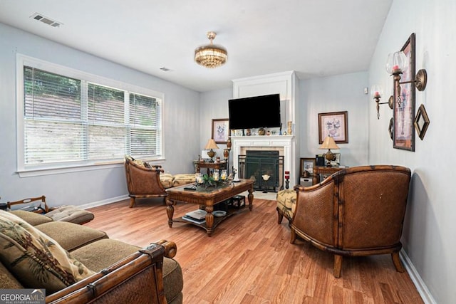 living room with a wealth of natural light and light hardwood / wood-style flooring